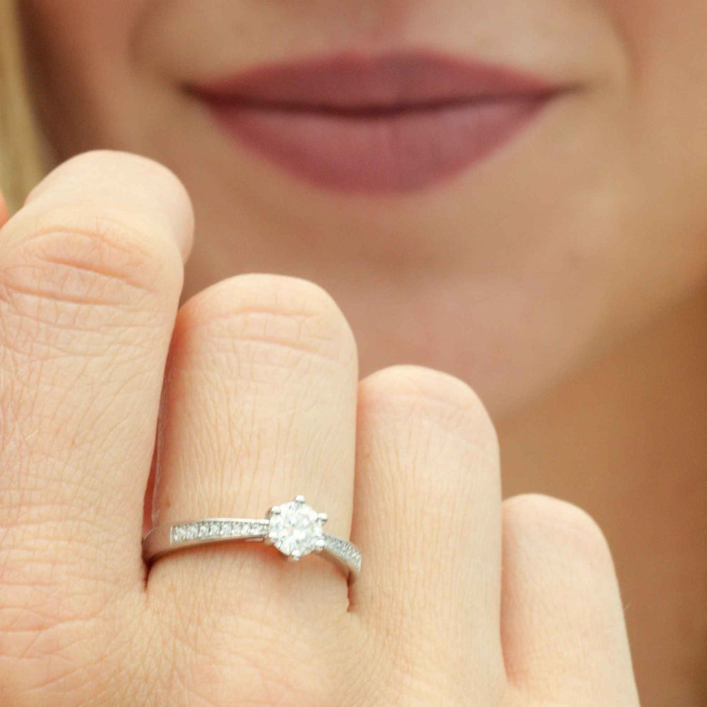Woman wearing 0.5 carat gold adjustable engagement ring with moissanite