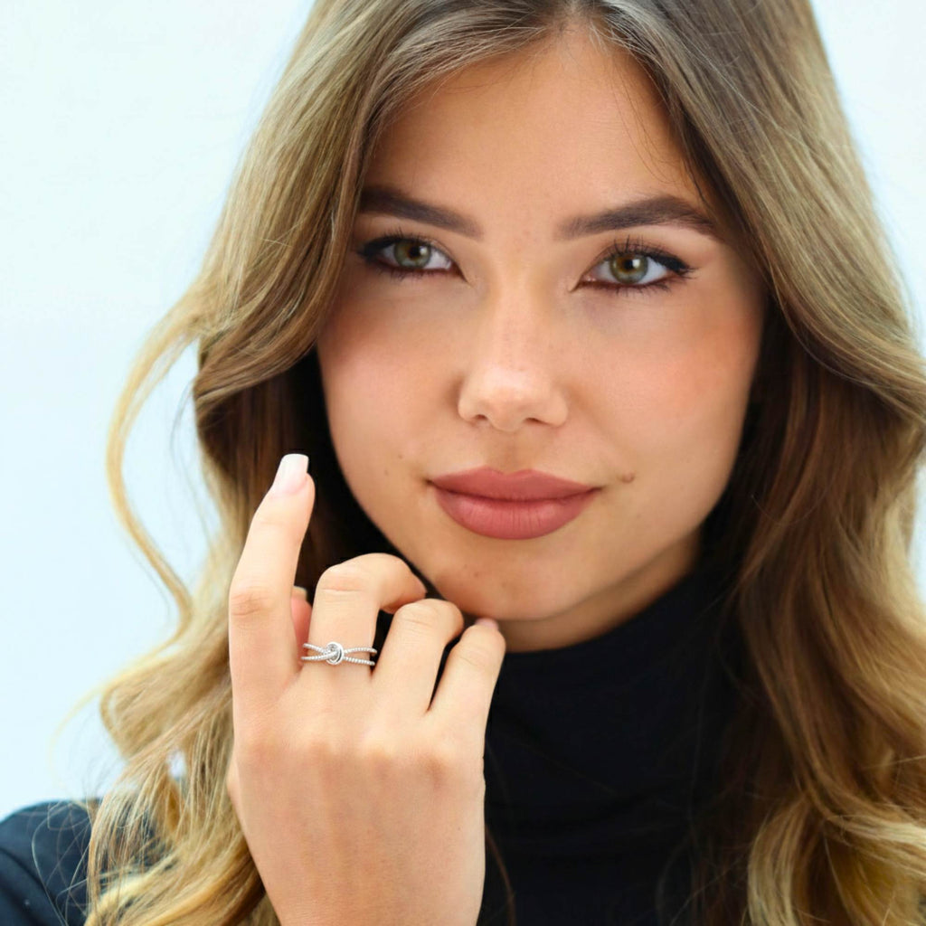 Model showcasing Satinski Dainty Adjustable Open Knot Ring in sterling silver