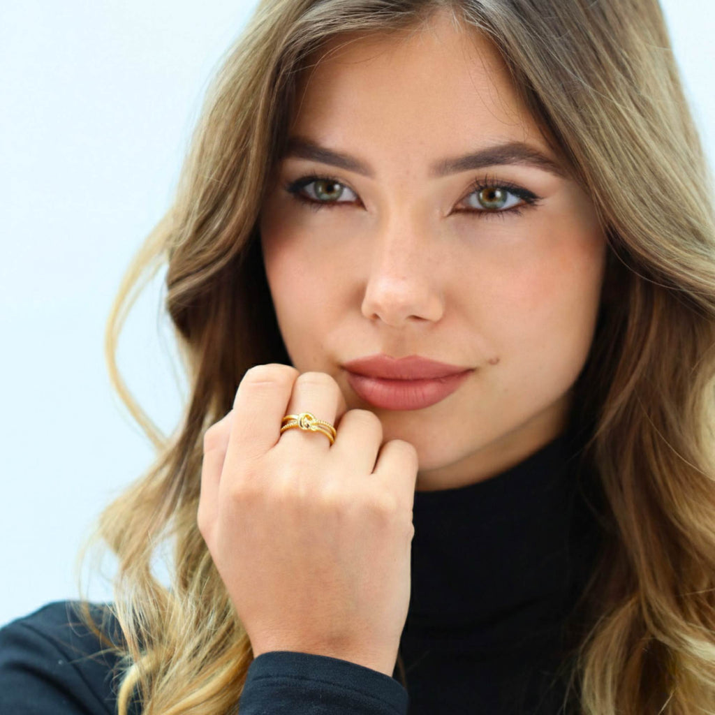 Woman wearing Satinski Dainty Adjustable Open Knot Ring in gold, styled with everyday look.