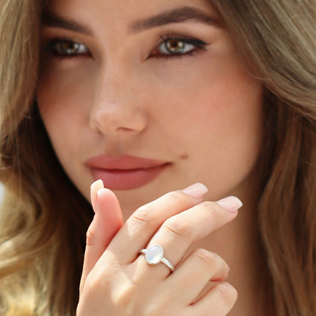 Close-up of hand wearing Satinski dainty adjustable open opal ring in sterling silver.